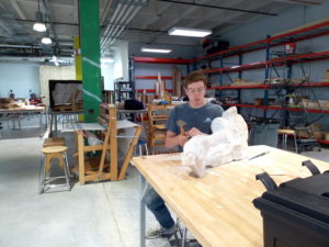Dana Hoppe, a student at the University of Nebraska-Lincoln works on his stone sculpture at the Nebraska Innovation Studio.