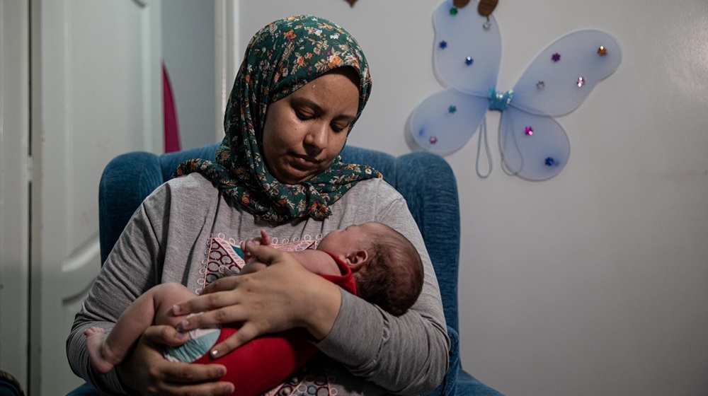 Mayada Reda holds her healthy newborn son, Mohamed. She was able to safely deliver in a quarantine hospital in Cairo UNFPA Egypt/Roger Anis
